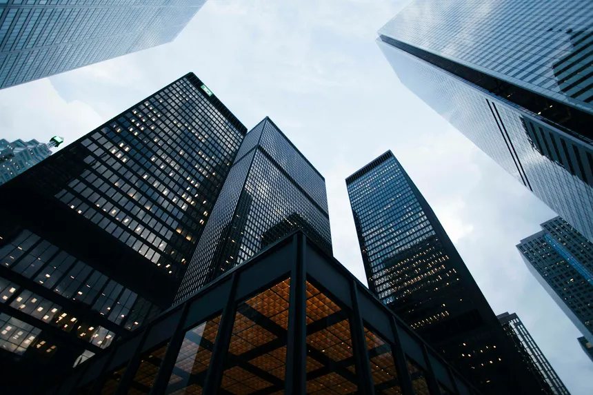 Black glass office towers viewed from below